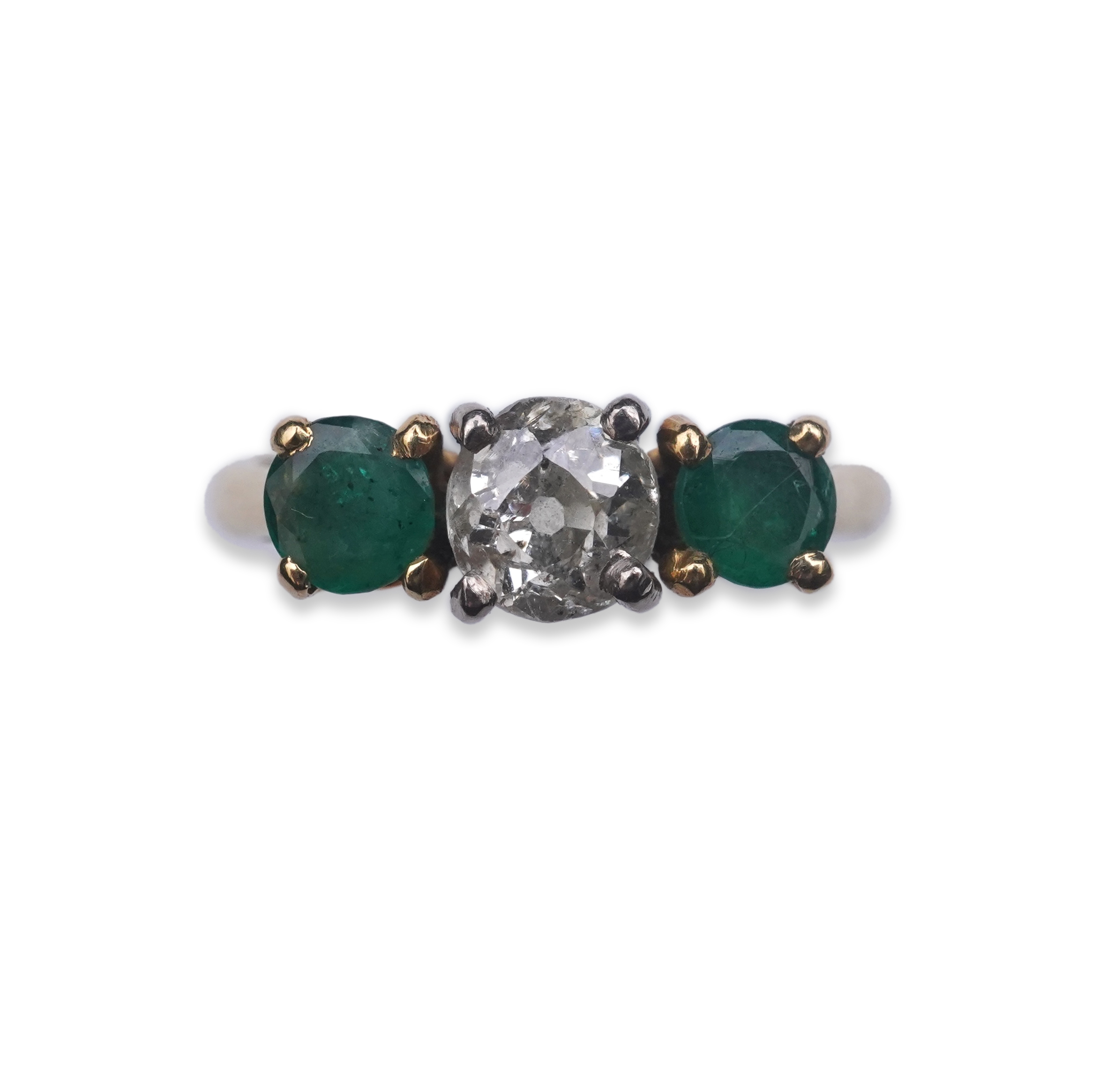 An emerald and diamond three-stone ring